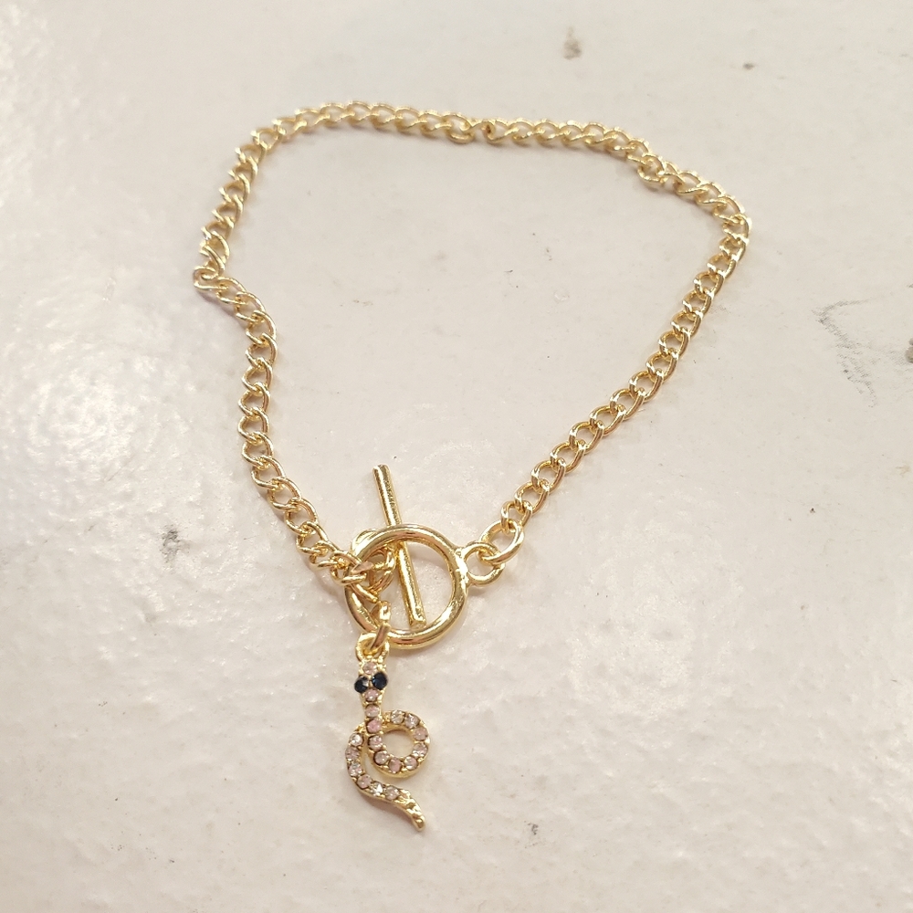 Gold bracelet with snake charm